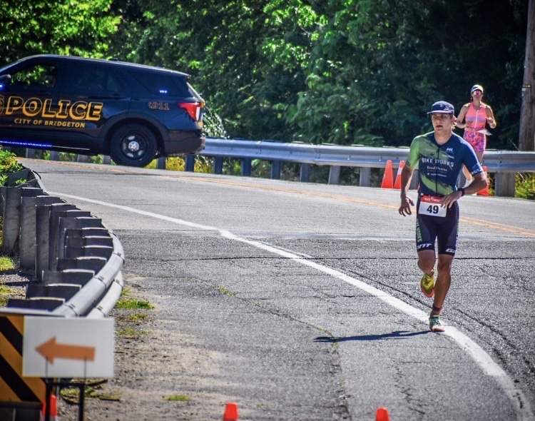Triathlete running on a road during a race