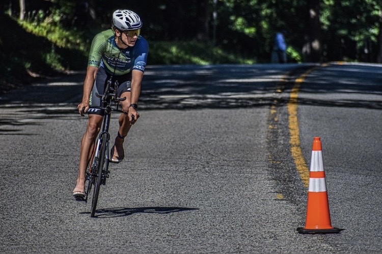 Cyclist riding past a cone on a race course